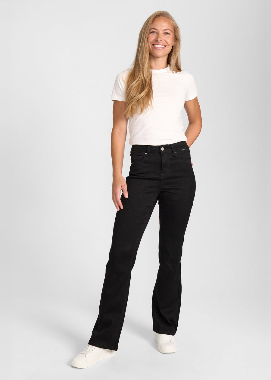 Fuldt billede af model i sort bootcut jeans.