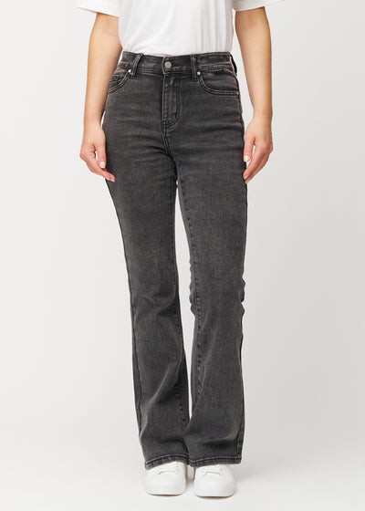 Dark grey mid-rise bootcut jeans in Shadows. Front view on a model, fitted through the hips and thighs with a gentle flare at the hem.