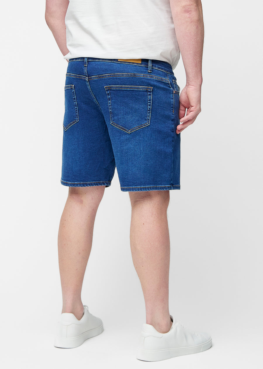 Dark blue denim shorts for men in the colour Oceans seen from the back on a plus-size model.