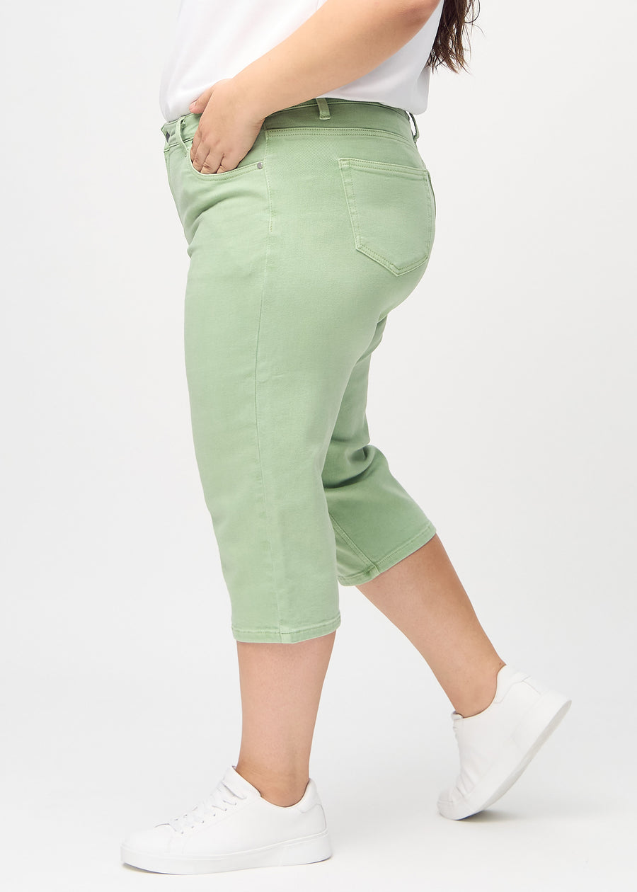 Light green regular capris seen from the side on a plus-size model.