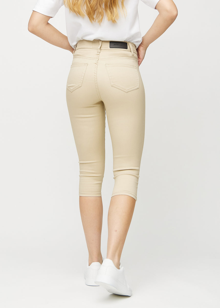 Beige skinny capris seen from the back, so the entire product is visible.