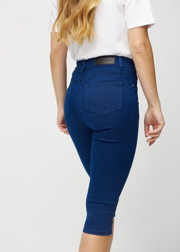 Dark blue skinny capris seen from the back close up to show details.