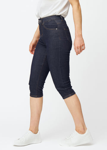 Deep dark blue denim capris for women in the colour Midnights with a slim fit seen from the side on a model.