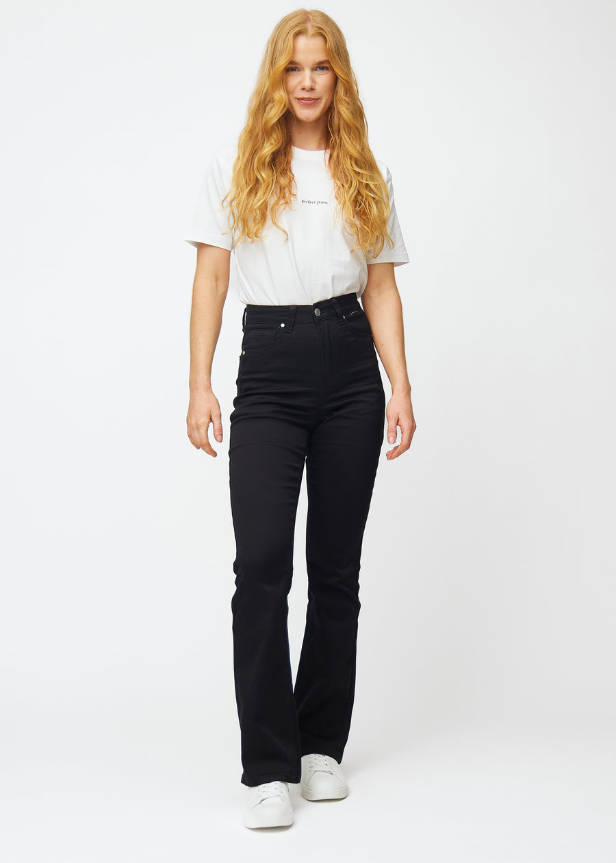 Full image of a model in black high-waisted bootcut jeans.