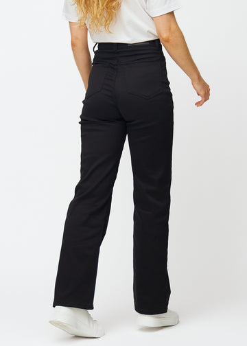 Black high-waisted jeans, which are fitted at the waist and have a loose fit with width down the leg, shown from the back to show the full product.