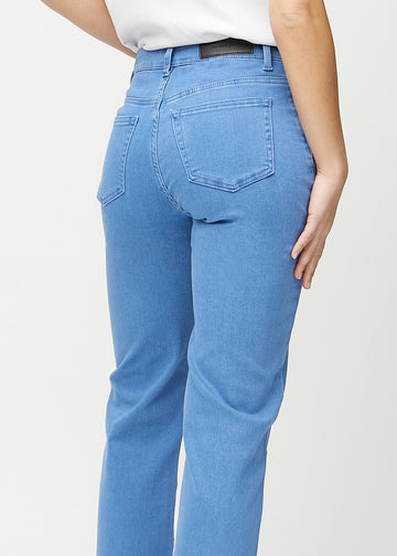 Blue loose jeans seen from the back close up to show details.