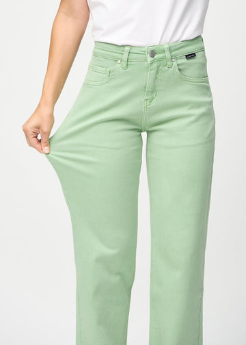 The model stretches the jeans at the thigh to show the stretch.

