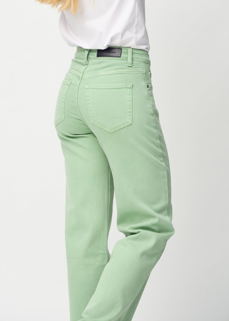 Light green loose jeans seen from the back close up to show details.
