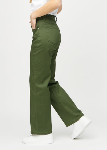 Dark green loose jeans seen from the side on a model.
