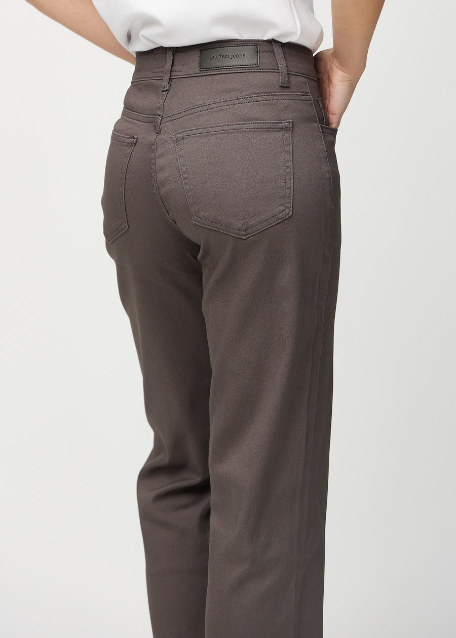Grey-brown loose jeans seen from behind close up to show details.