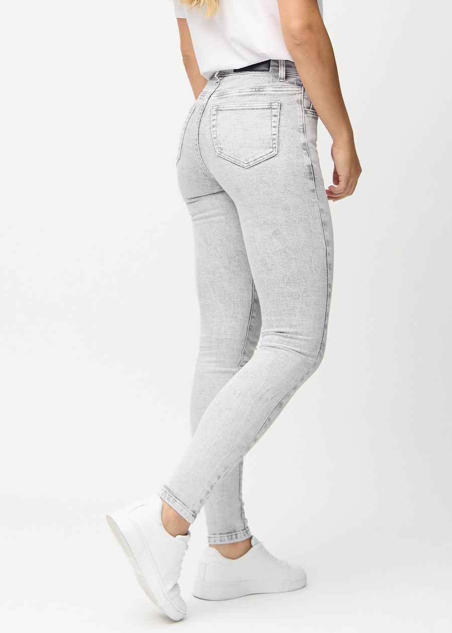 Light grey denim skinny jeans seen from the back, so the entire product can be seen.