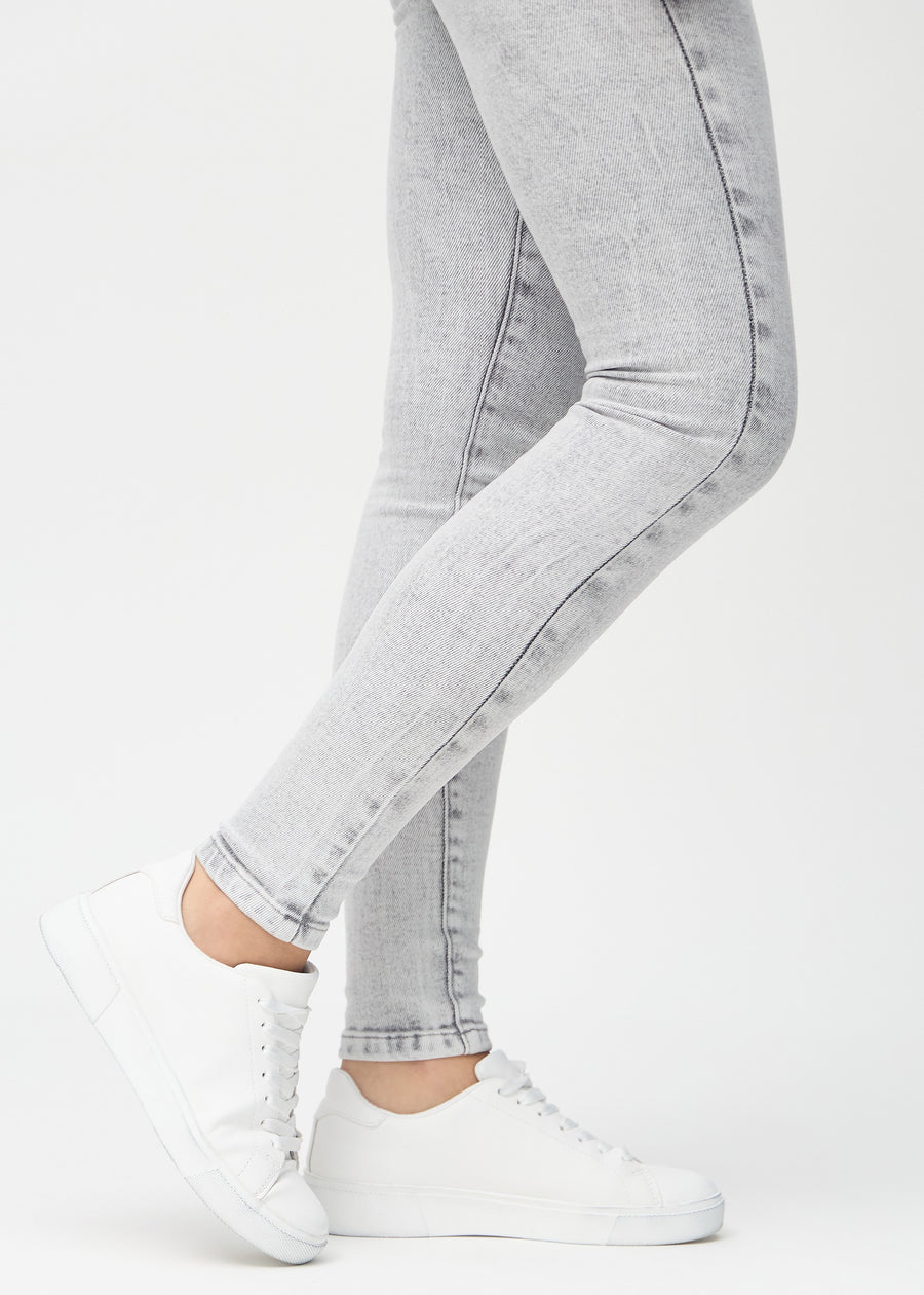 The ankles of a model, so you can see how tightly the jeans fit.