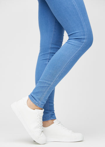 The ankles of a model, so you can see how tightly the jeans fit.