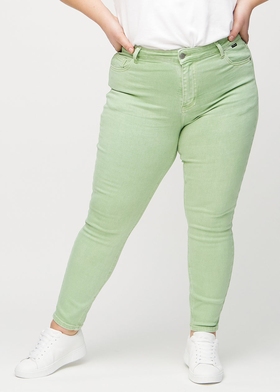 Skinny jeans for women in light green, color Mints. Front view on a plus-size model, showing the close fit through the legs.