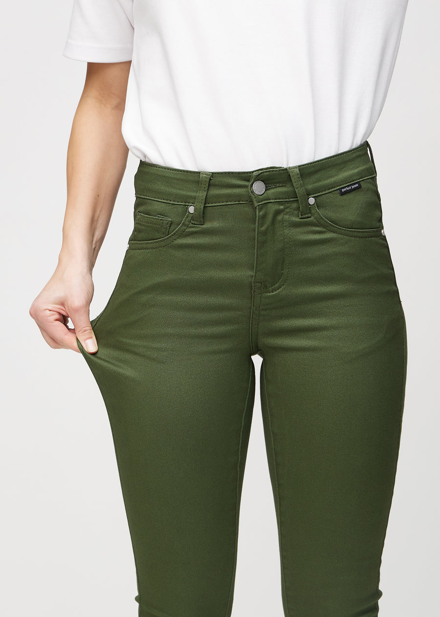 The model stretches the jeans at the thigh to show the stretch.
