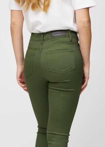 Dark green skinny jeans seen from the back close up to show details.