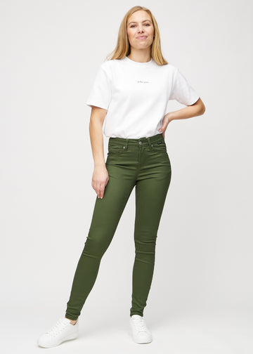 Full image of model in dark green skinny jeans.