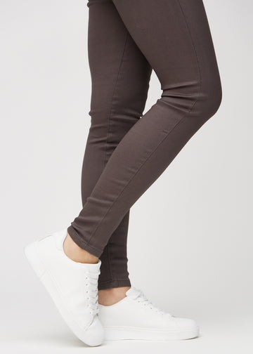 The ankles of a model, so you can see how tightly the jeans fit.