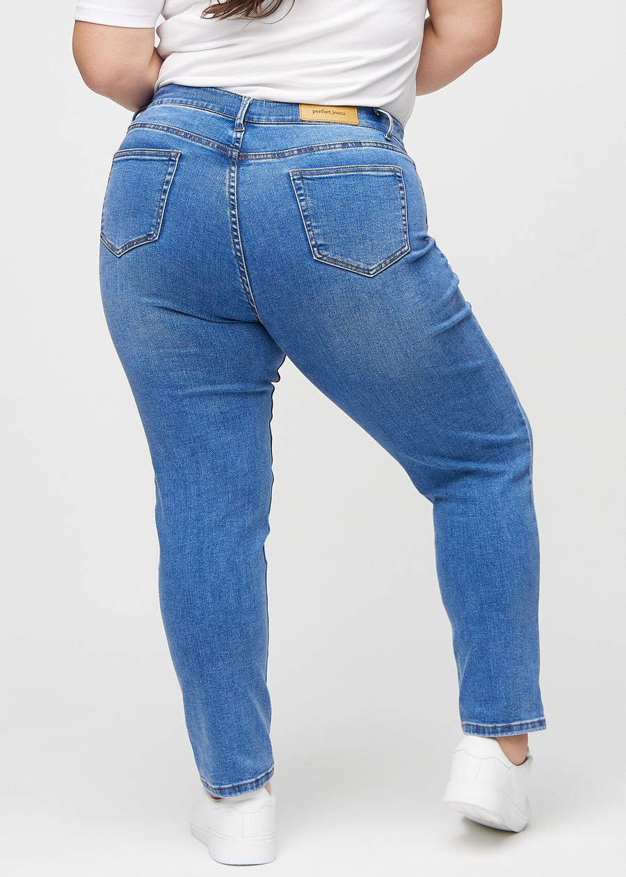 Slim jeans for women in blue, color Rivers. Back view on a plus-size model, showing the overall fit.
