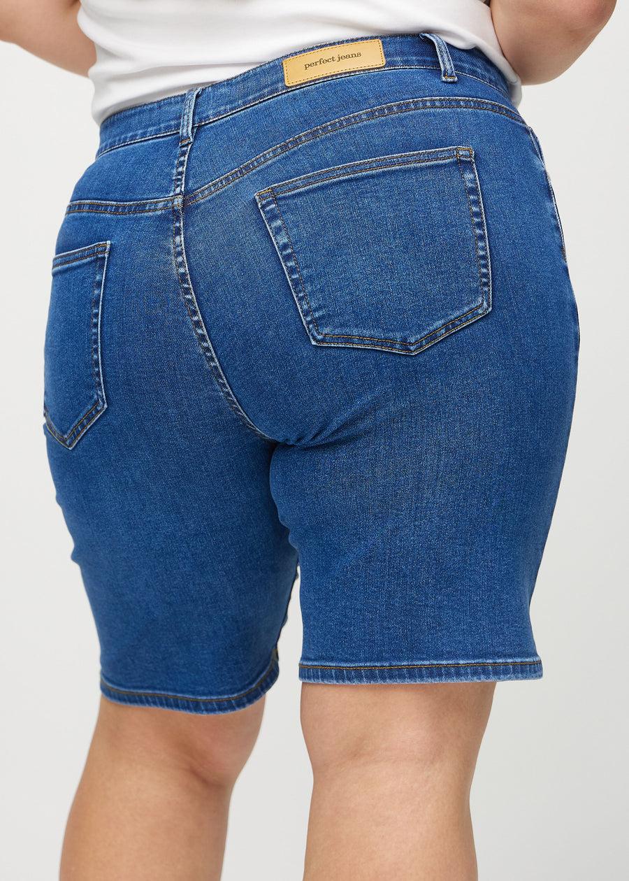 Dark denim regular middle shorts seen from the back close up on a plus-size model to show details.