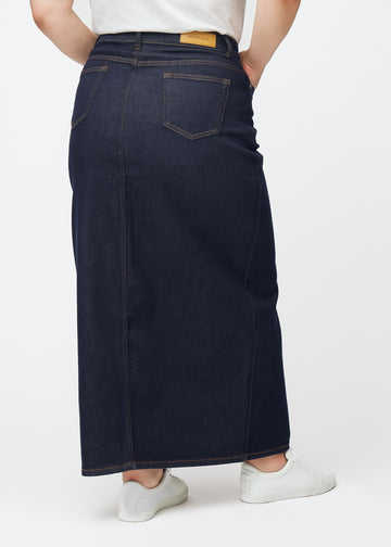 Long deep dark blue denim skirt for women in the colour Midnights seen from the back on a plus-size model, showing the full length.