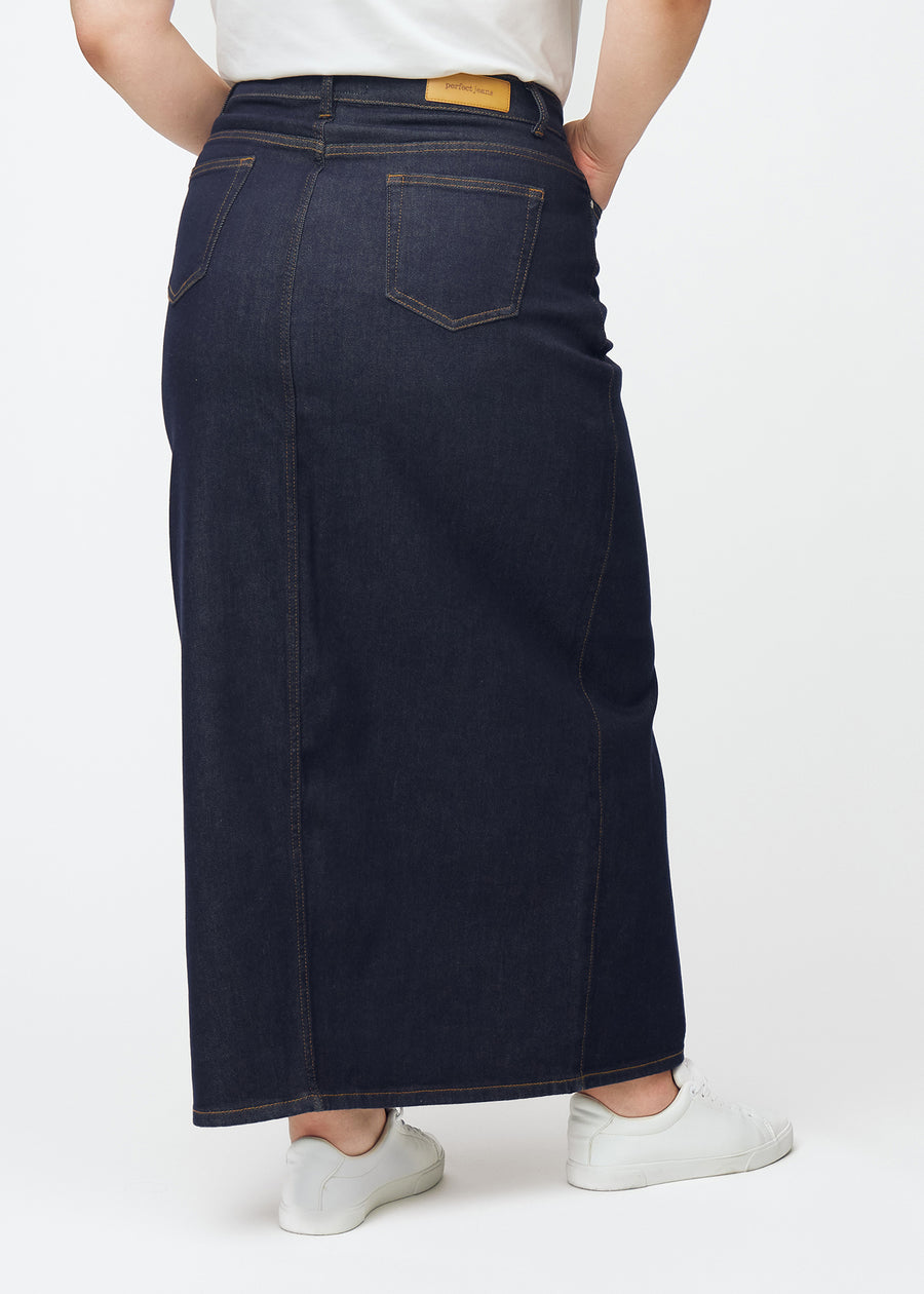 Long deep dark blue denim skirt for women in the colour Midnights seen from the back on a plus-size model, showing the full length.
