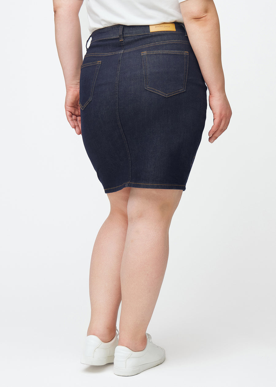 Deep dark blue denim skirt for women in the colour Midnights seen from the back on a plus-size model.
