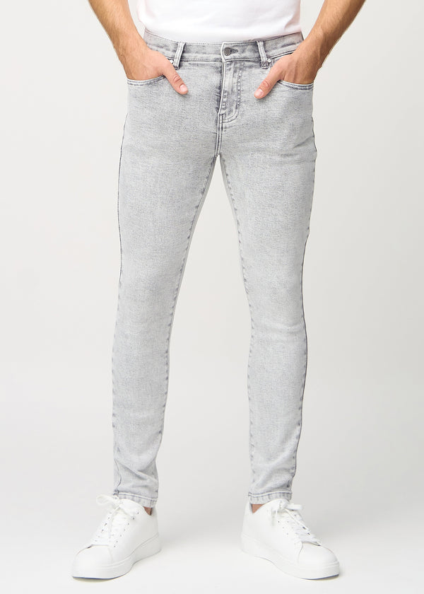 Light grey denim slim jeans, model name Ashes, fitted closely along the legs , front view.