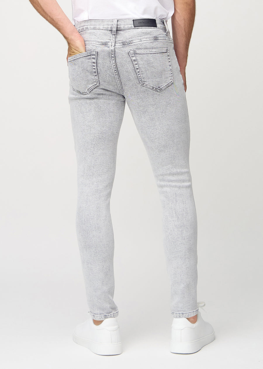 Light grey denim slim jeans viewed from the back to show the full product.