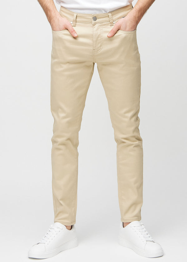 Beige slim jeans, model name Gazelles, fitted closely along the legs , front view.