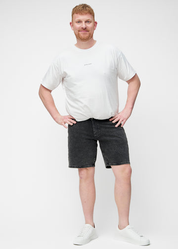 Full image of a plus-size model wearing dark grey denim shorts for men in the colour Shadows with a regular fit.