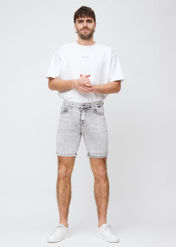 Full image of model in light grey denim middle-slim shorts.