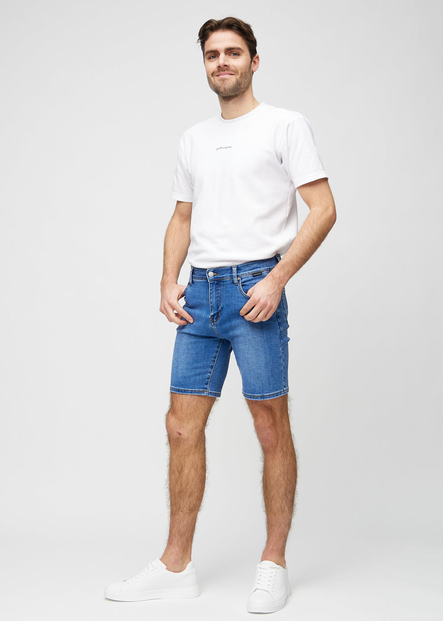 Full image of model in denim middle-slim shorts.