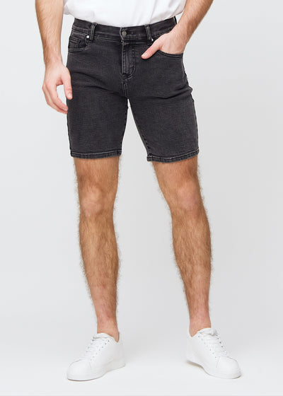 Dark grey denim middle-slim shorts, which fit straight along the thigh and end just above the knee, seen from the front.