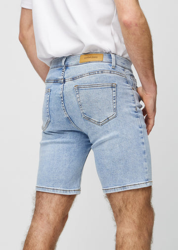 Light denim middle-slim shorts seen from the back in close-up to show details.