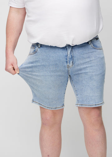 The plus-size model stretches the shorts at the thigh to show the stretch.